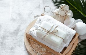 Soap wrapped on a towel on a wooden plate